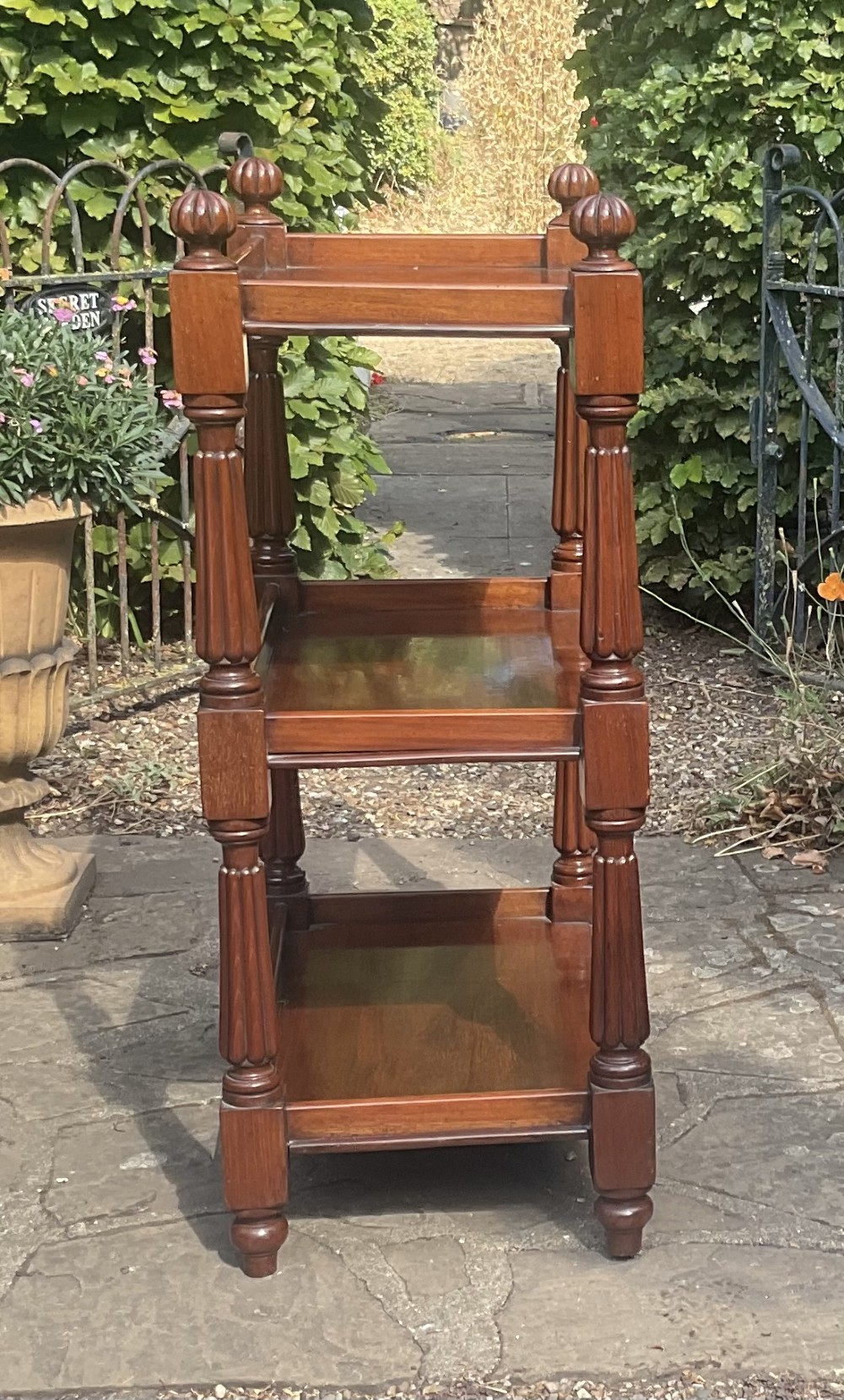 A Victorian mahogany three-tier etagere featuring reeded vertical supports, turned finials, and gallery rimmed shelves. View III