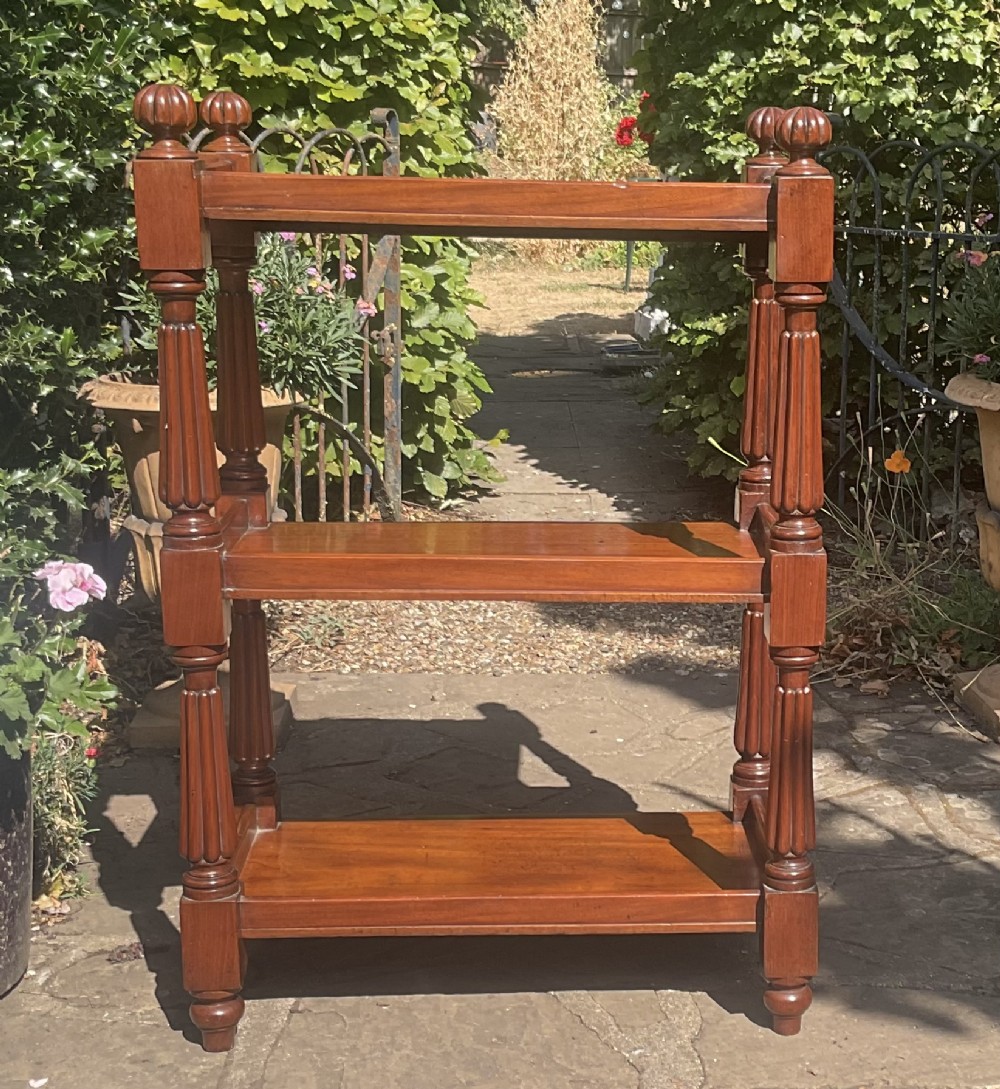 A Victorian mahogany three-tier etagere featuring reeded vertical supports, turned finials, and gallery rimmed shelves. View VI