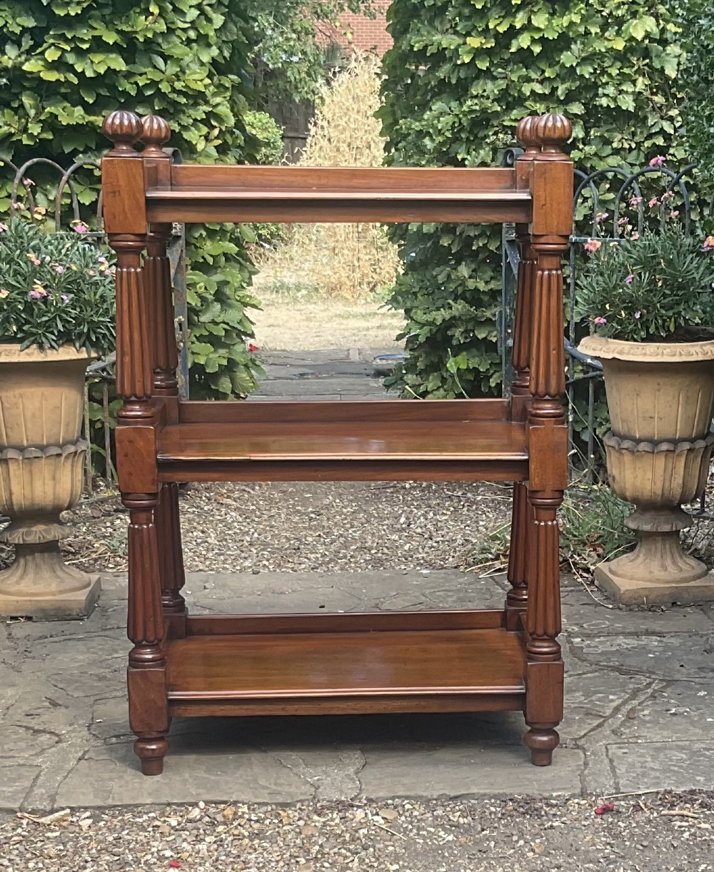 A Victorian mahogany three-tier etagere featuring reeded vertical supports, turned finials, and gallery rimmed shelves. View VII