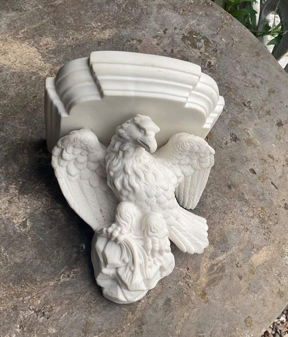A Victorian off-white Parian porcelain wall bracket featuring a sculpted eagle with outstretched wings perched beneath a stepped shelf ledge. View II