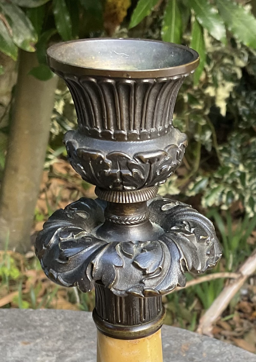 A pair of Regency period candlesticks with yellow marble column stems, classical dark bronze sconces, acanthus collars, and bronze paw feet on triform marble bases. View V