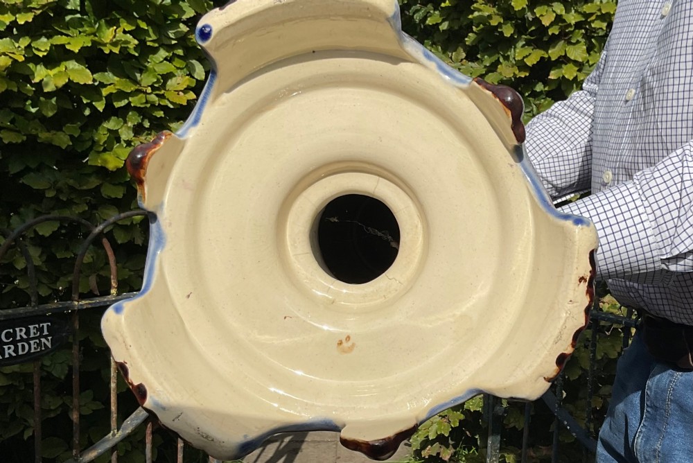 A late Victorian glazed majolica ceramic jardiniere resting atop a matching relief-moulded pedestal stand with brown, blue, and pink glazes. View V