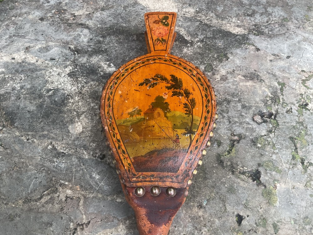 A Regency-period hand-painted wooden fire bellows featuring a painted landscape scene, brass nozzle, tan leather sides, and decorative brass studs. View III