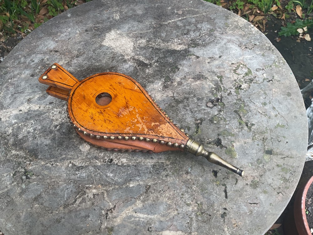 A Regency-period hand-painted wooden fire bellows featuring a painted landscape scene, brass nozzle, tan leather sides, and decorative brass studs. View IV