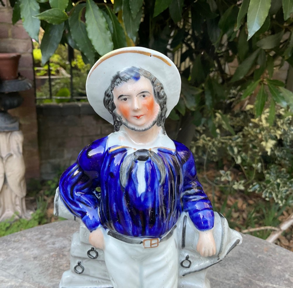 A Victorian Staffordshire earthenware figure depicting an English sailor leaning on a cannon with the base inscribed Ready and Willing. View III