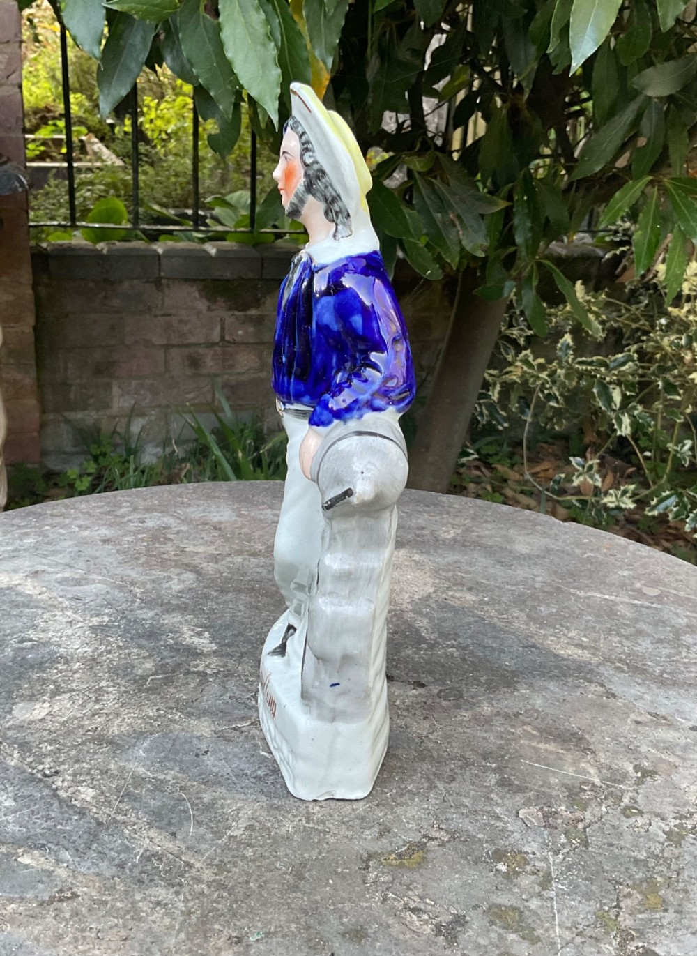 A Victorian Staffordshire earthenware figure depicting an English sailor leaning on a cannon with the base inscribed Ready and Willing. View IV