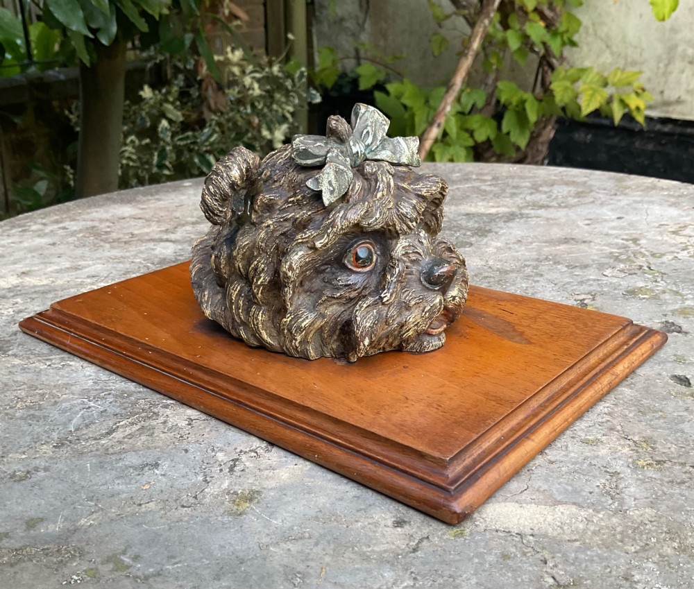 An antique Austrian cold-painted bronze head of a Yorkshire Terrier with a green bow, mounted on a rectangular timber base as a spring paper clip. View VI