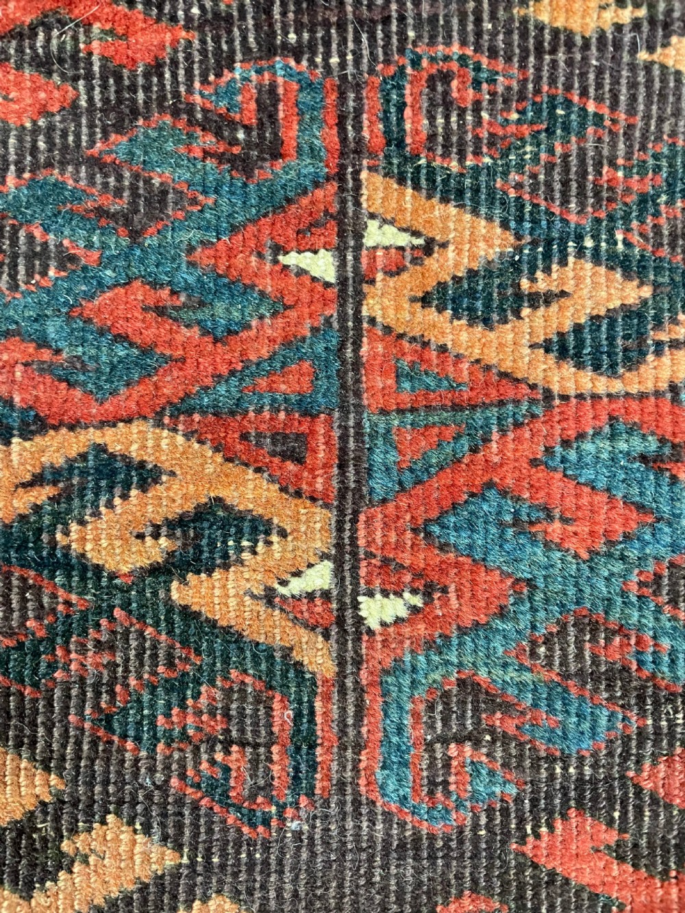 An antique Yomut Turkoman hand-knotted wool rug featuring repeating geometric diamond lattice motifs in deep red, navy blue, and ivory shades. View VIII