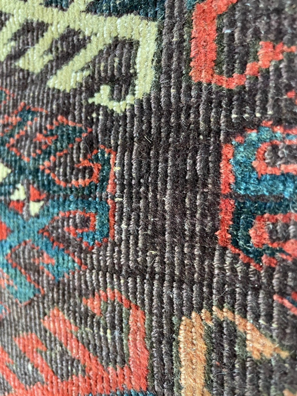 An antique Yomut Turkoman hand-knotted wool rug featuring repeating geometric diamond lattice motifs in deep red, navy blue, and ivory shades. View IX