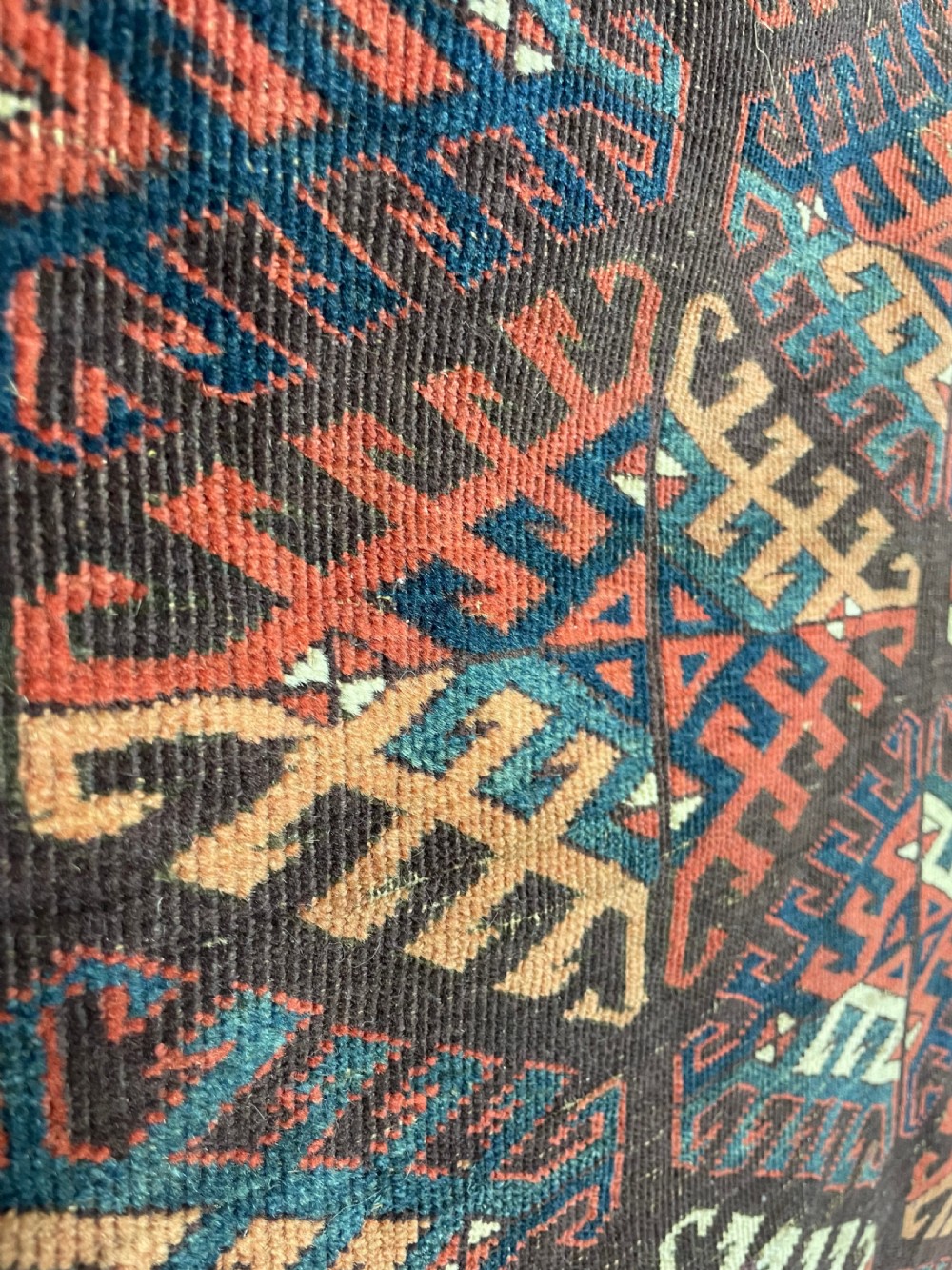 An antique Yomut Turkoman hand-knotted wool rug featuring repeating geometric diamond lattice motifs in deep red, navy blue, and ivory shades. View XI