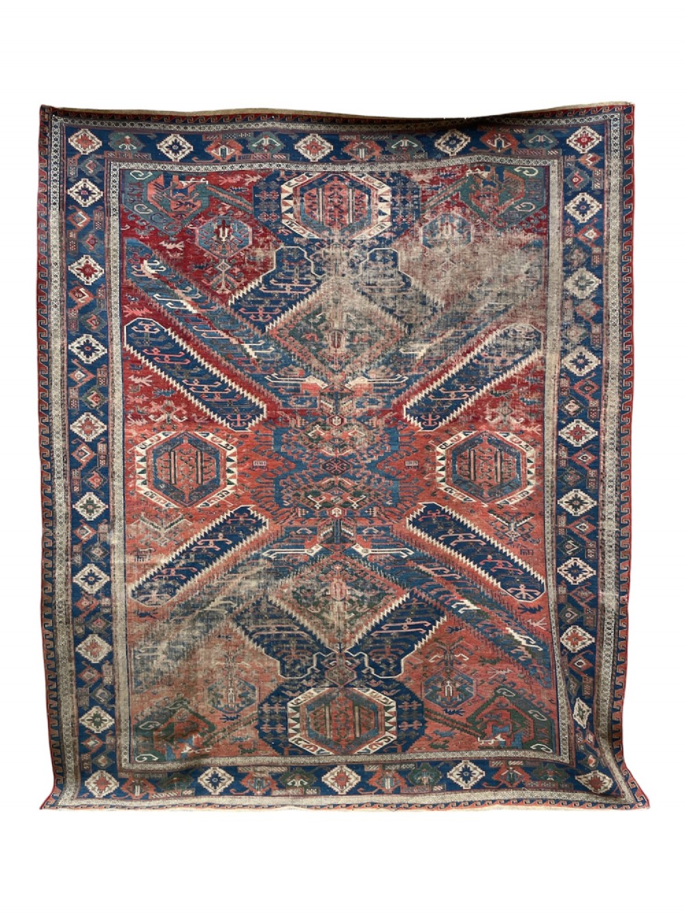 An antique Caucasian Dragon Soumak flatweave wool rug featuring geometric diamond medallions and dragon motifs in terracotta red, navy blue, and teal green. View V