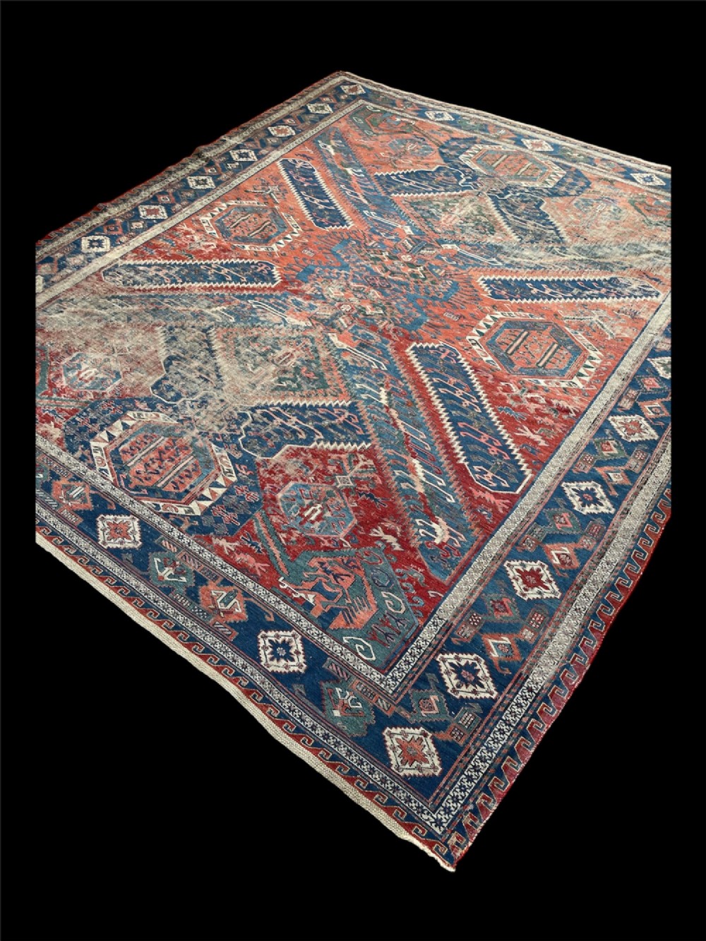 An antique Caucasian Dragon Soumak flatweave wool rug featuring geometric diamond medallions and dragon motifs in terracotta red, navy blue, and teal green. View VI