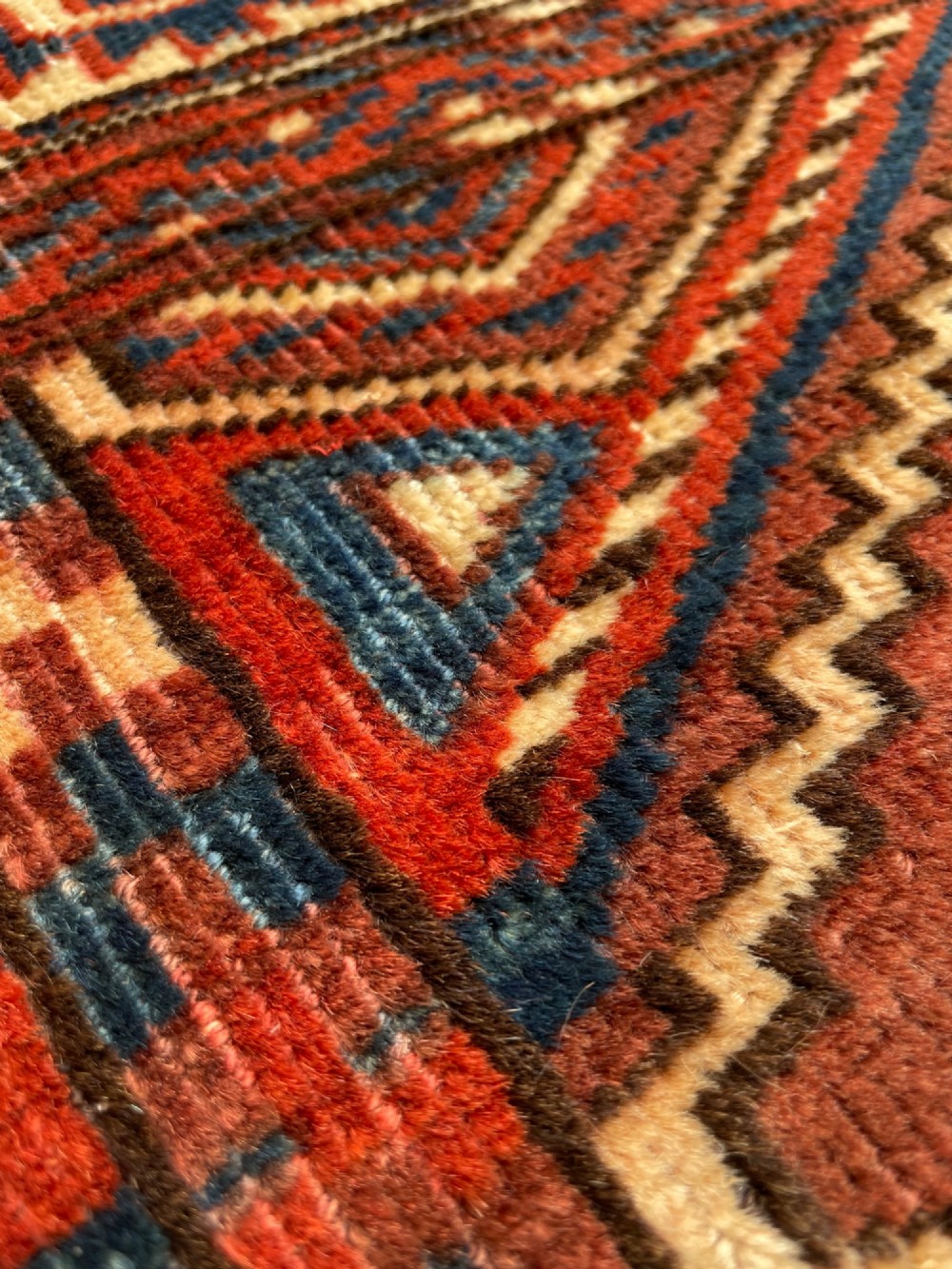 A large antique hand-knotted wool Turkoman Yomut carpet featuring repeating geometric gol motifs on a deep red ground surrounded by geometric borders. View VII