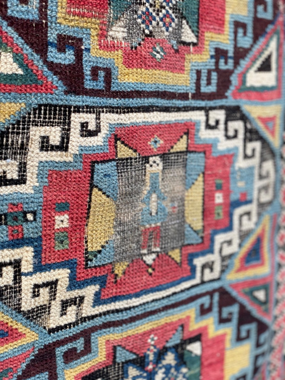 A long hand-knotted wool Shirvan runner rug featuring a central row of geometric stepped medallions framed by detailed multi-coloured bird and hook borders. View IX