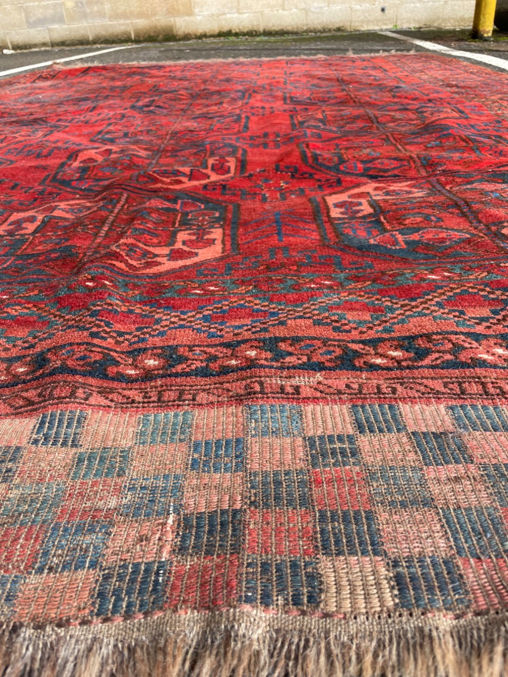 An antique Afghan Ersari hand-knotted wool carpet featuring repeating octagonal gol motifs on a deep red field with geometric borders. View V