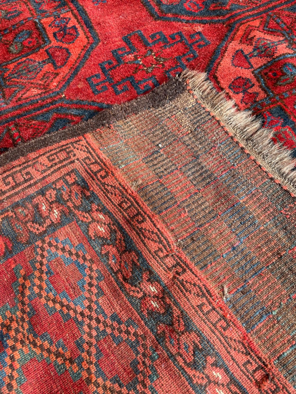 An antique Afghan Ersari hand-knotted wool carpet featuring repeating octagonal gol motifs on a deep red field with geometric borders. View VI