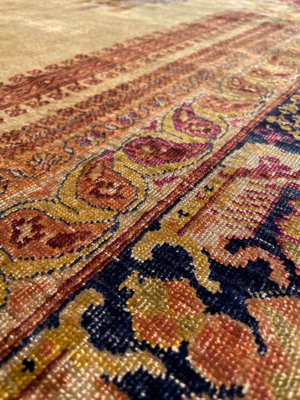 A 19th-century Anatolian silk prayer rug featuring a central gold niche with a hanging lamp motif, enclosed by navy blue and crimson floral borders. View V