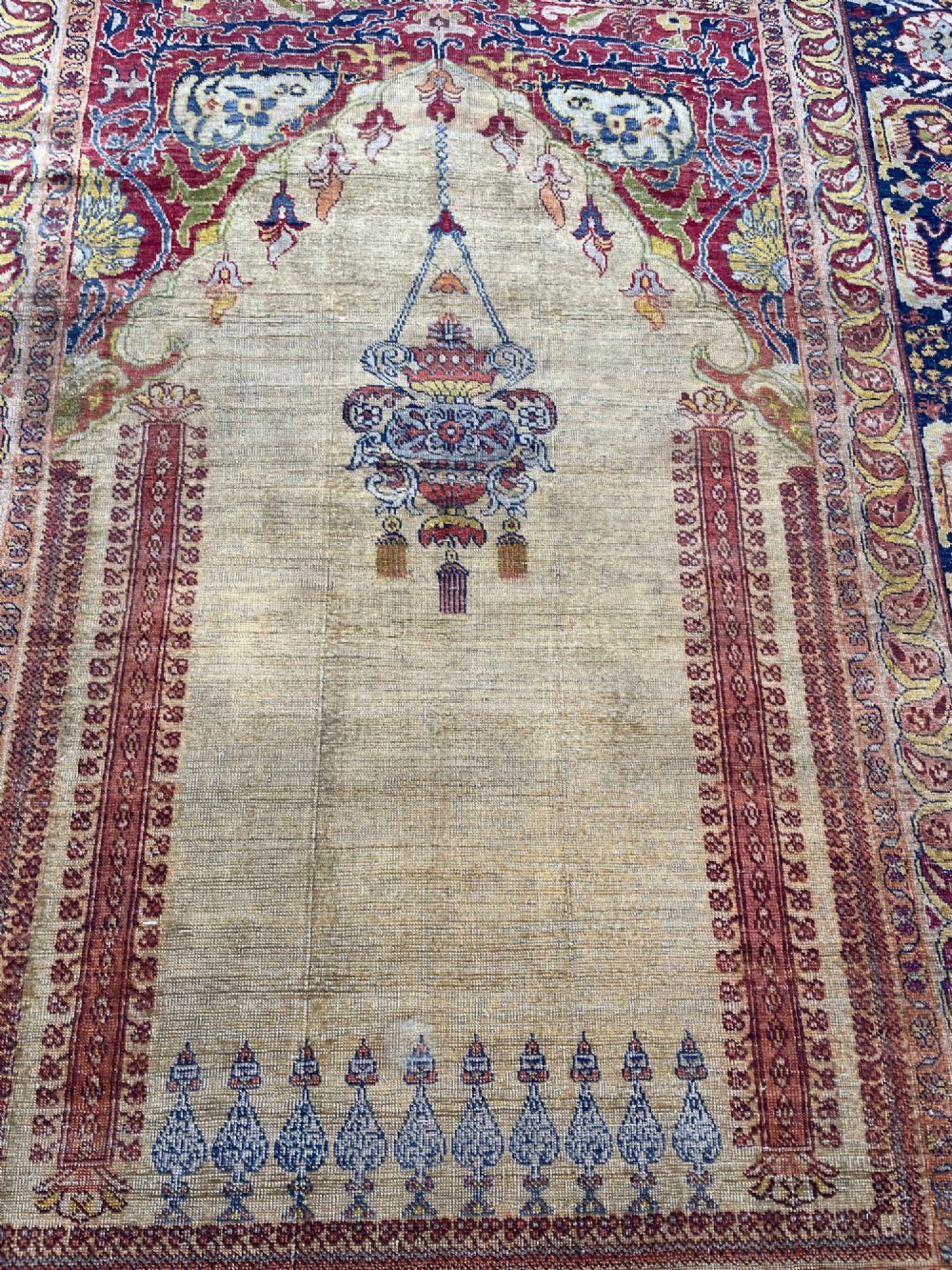 A 19th-century Anatolian silk prayer rug featuring a central gold niche with a hanging lamp motif, enclosed by navy blue and crimson floral borders. View VII