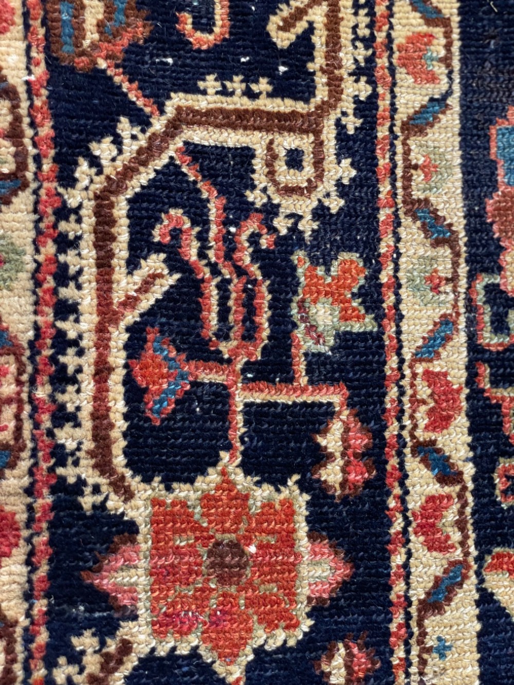 An antique hand-knotted Persian Jozan wool rug featuring a dark navy field filled with floral motifs around a central terracotta red diamond medallion and matching spandrels. View VIII
