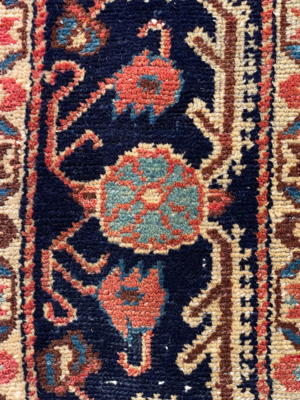 An antique hand-knotted Persian Jozan wool rug featuring a dark navy field filled with floral motifs around a central terracotta red diamond medallion and matching spandrels. View IX