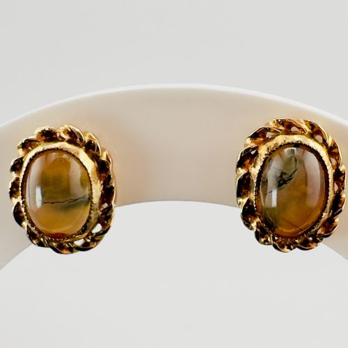 fig 1. A pair of oval gold stud earrings with cabochon tigers eye gemstones framed by a twisted rope border.