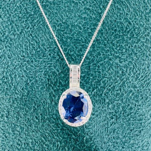 fig 1. Platinum Oval Cut Sapphire and Diamond Cluster Pendant on White Gold Chain