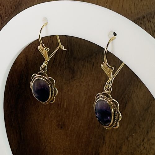 fig 1. A pair of 9ct yellow gold drop earrings featuring oval purple Blue John cabochons set within decorative rope-twist frames.