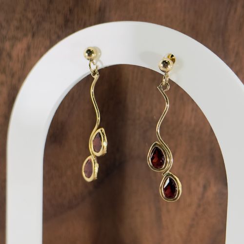 fig 1. Pair of 9ct yellow gold drop earrings with ball studs, wavy wire drops, and two bezel-set teardrop garnets.