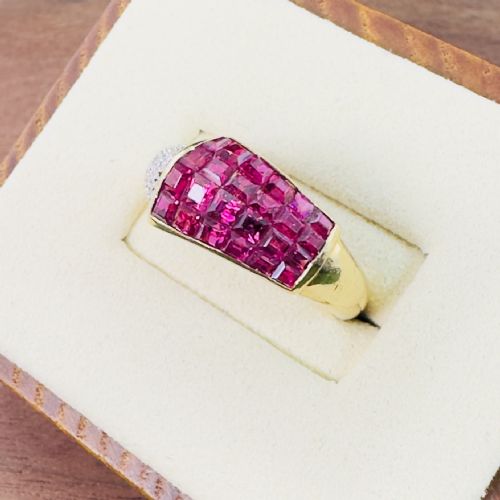 fig 1. An 18ct yellow gold dress ring featuring a square panel of princess-cut red rubies alongside a curved band of pave-set diamonds.