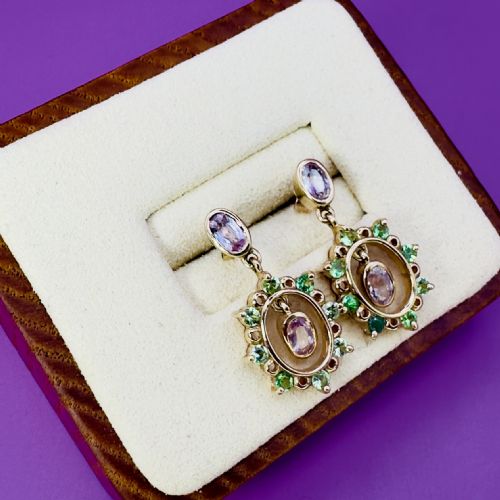 fig 1. A pair of 9ct yellow gold drop earrings featuring oval pink sapphire studs suspending cluster drops set with green peridots and central pink sapphires.