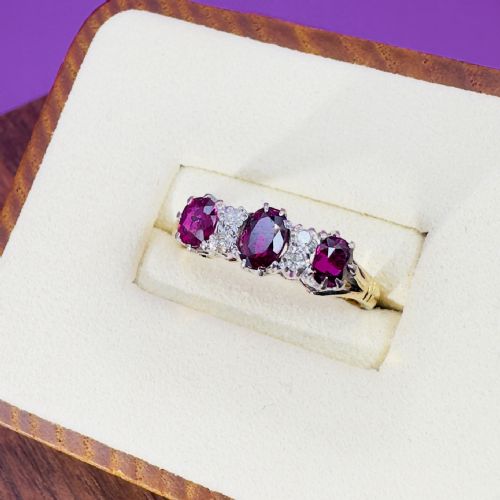 fig 1. An Edwardian 18ct yellow gold ring featuring three oval red rubies set with small old-cut diamonds between them.