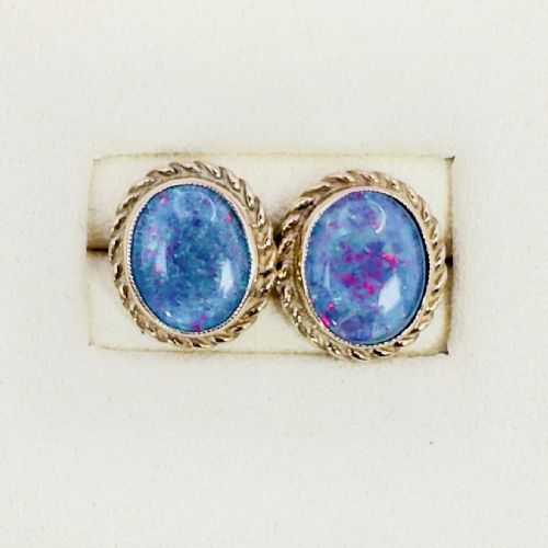 fig 1. A pair of oval 9ct gold stud earrings set with iridescent black opal doublets and bordered by a twisted rope pattern.