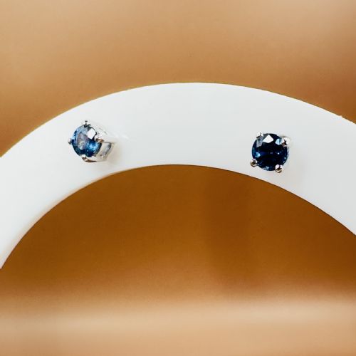 fig 1. A pair of round blue sapphire stud earrings set in four-prong 18ct white gold mountings.