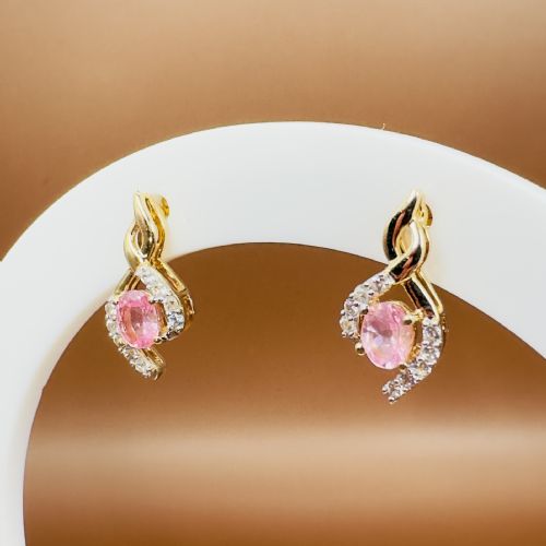 fig 1. A pair of 10ct yellow gold stud earrings featuring oval pink sapphires encased in swirling diamond-accented mounts.