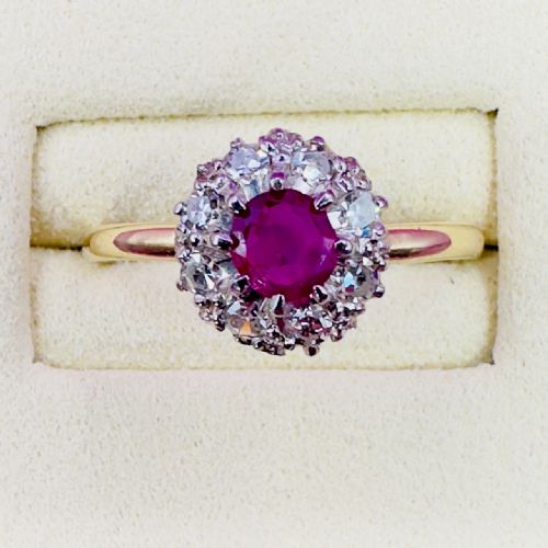 fig 1. An 18ct yellow gold Art Deco cluster ring featuring a central round ruby surrounded by a halo of diamonds.