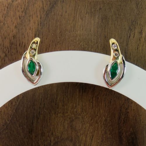 fig 1. A pair of two-tone 14ct gold stud earrings, each featuring a central marquise-cut green emerald framed by a white gold curve and set with two small round diamonds.