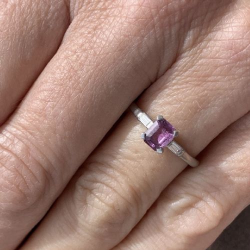 fig 1. An Art Deco platinum ring set with a central rectangular pink sapphire flanked by two baguette-cut diamonds.