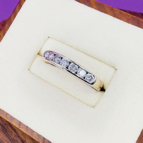 fig 1. An 18ct white gold half eternity ring featuring seven round brilliant diamonds set horizontally into the band.