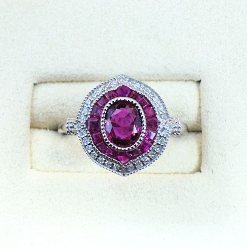 PLATINUM OVAL CUT RUBY AND DIAMOND CLUSTER RING