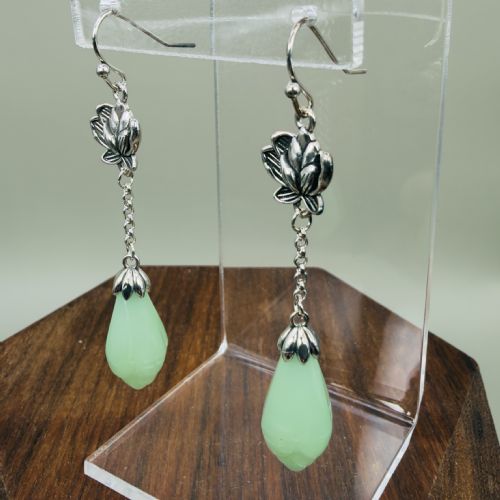 fig 1. Pair of sterling silver drop earrings with lotus flower motif mounts, delicate trace chains, and carved mint-green chalcedony teardrop pendants on hook wires.