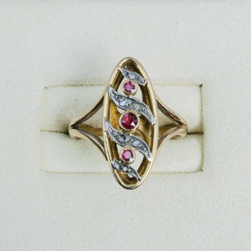 fig 1. An 18ct gold Art Nouveau navette ring featuring three round rubies set within an openwork marquise-shaped mount detailed with diamonds.
