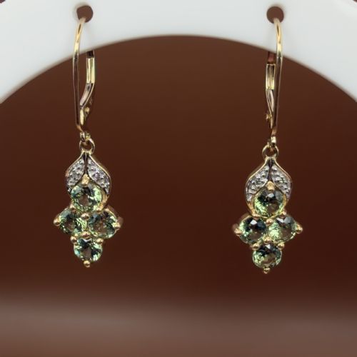 fig 1. A pair of 9ct yellow gold drop earrings featuring a cluster of round-cut teal green sapphires suspended from hinge back hooks with diamond accent detail.