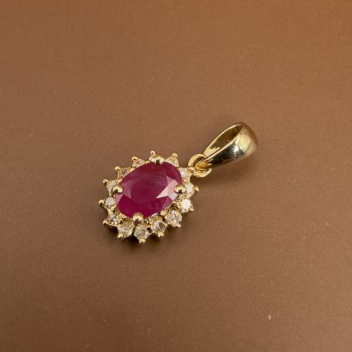 fig 1. A 14ct yellow gold cluster pendant featuring an oval-cut red ruby framed by small round diamonds.