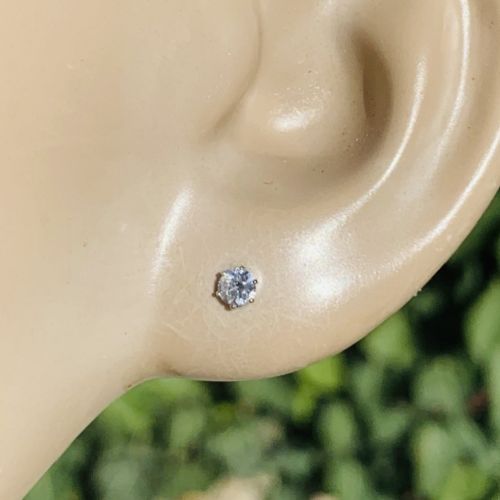 A pair of round brilliant-cut solitaire diamond stud earrings set in six-claw platinum mounts. View V