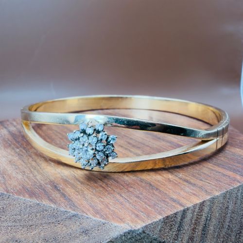 fig 1. A solid 9ct yellow gold split-band cuff bangle featuring a central multi-stone diamond cluster set in a tiered round formation.