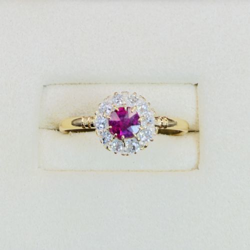 fig 1. An 18ct yellow gold Victorian ring featuring a central round red ruby surrounded by a halo of hand-cut diamonds.