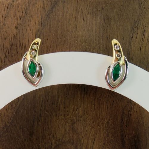fig 1. A pair of two-tone 14ct gold stud earrings set with marquise-cut green emeralds and small round diamonds.