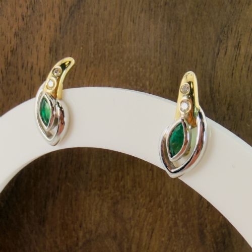 fig 2. A pair of two-tone 14ct gold stud earrings set with marquise-cut green emeralds and small round diamonds.
