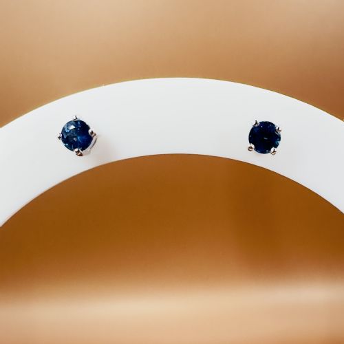 fig 1. A pair of round-cut blue sapphire stud earrings set in four-claw 18ct white gold mounts.
