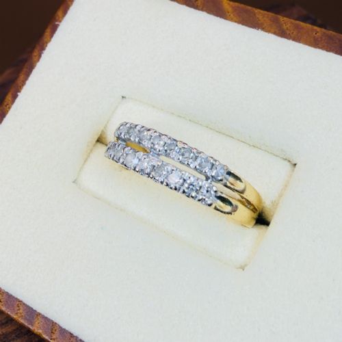 fig 1. An 18ct yellow gold ring featuring a double row band set with round diamonds across the top half.